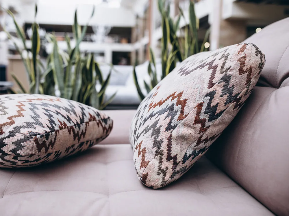 Rumors Pearl collection cushions on a soft neutral sofa